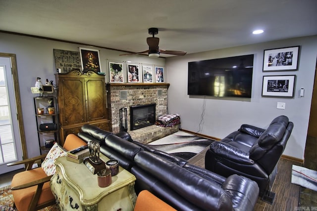 living room with ceiling fan, wood-type flooring, and a fireplace