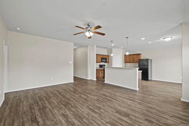 unfurnished living room with ceiling fan and dark wood-type flooring