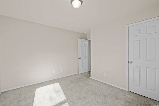 unfurnished bedroom featuring light colored carpet