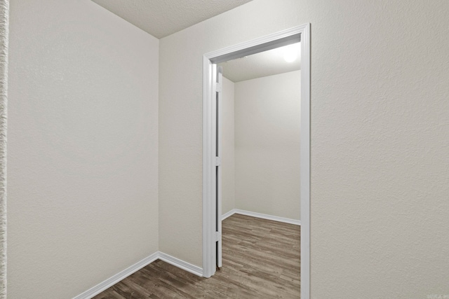 hallway with dark hardwood / wood-style floors