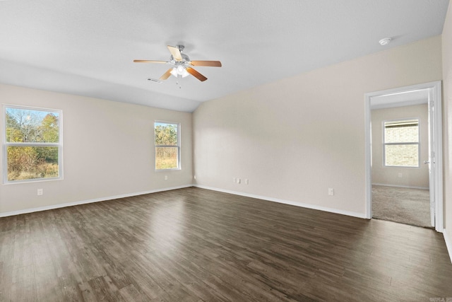 spare room with dark wood-type flooring and a healthy amount of sunlight