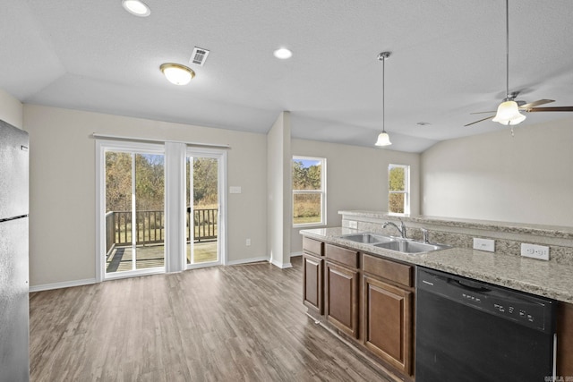 kitchen with black dishwasher, dark hardwood / wood-style floors, vaulted ceiling, and sink