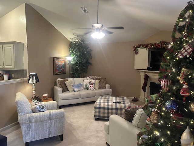 living room with ceiling fan, light carpet, and vaulted ceiling