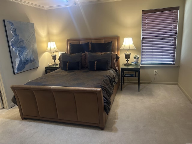 bedroom with ornamental molding and light carpet