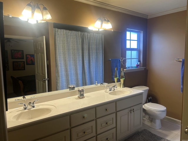 bathroom featuring tile patterned floors, crown molding, vanity, and toilet