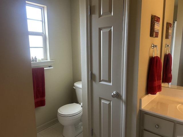 bathroom with tile patterned flooring, vanity, and toilet