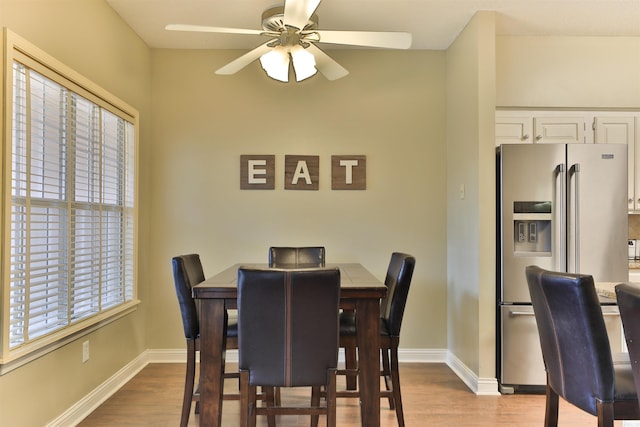 dining area featuring light wood-type flooring and ceiling fan