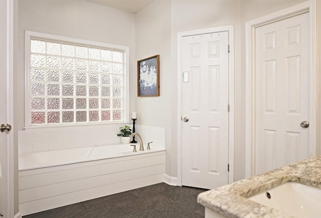 bathroom with a bathtub and vanity