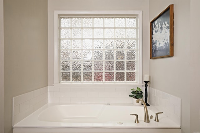 bathroom featuring a tub to relax in and a wealth of natural light