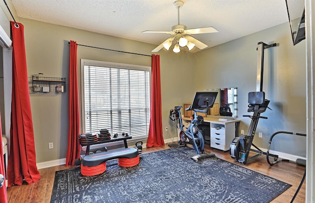 miscellaneous room with ceiling fan, hardwood / wood-style floors, and a textured ceiling