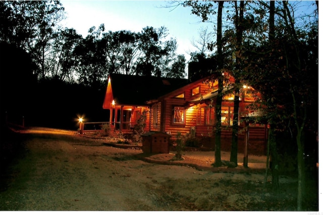 view of back house at dusk