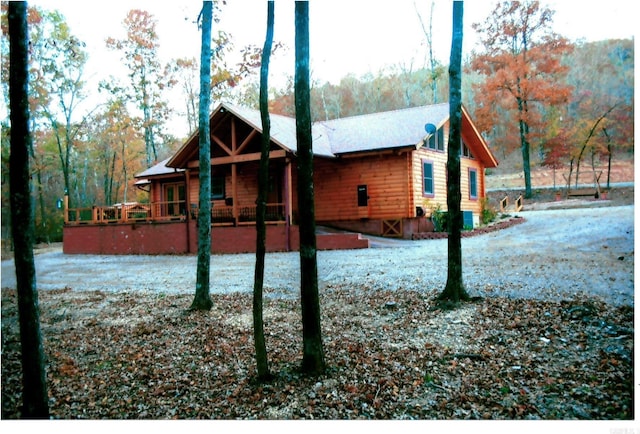 view of side of property with a wooden deck