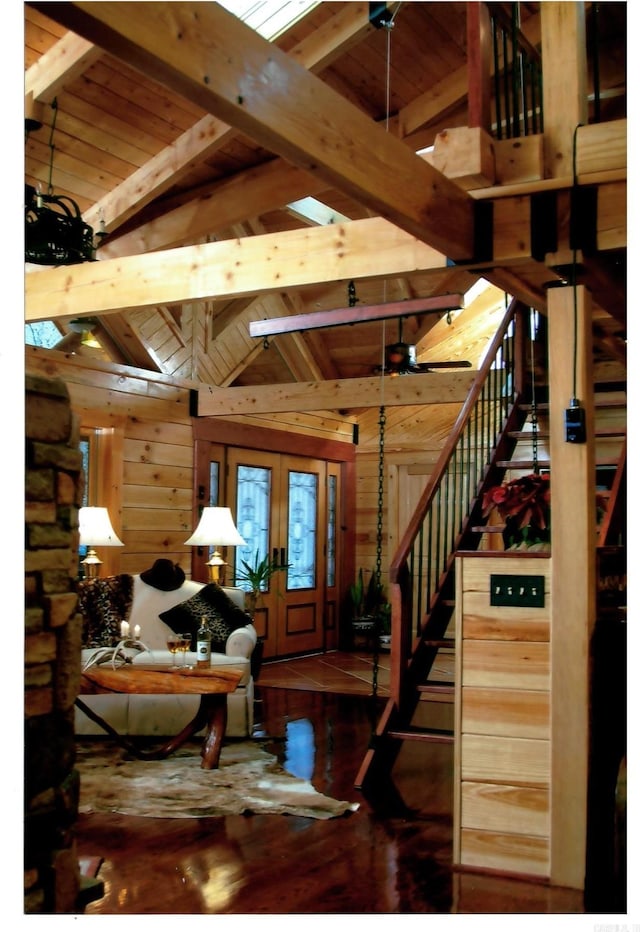 living room with french doors, vaulted ceiling with beams, dark wood-type flooring, and wood ceiling