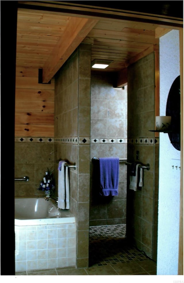 bathroom with tile patterned floors, independent shower and bath, beamed ceiling, and wooden ceiling