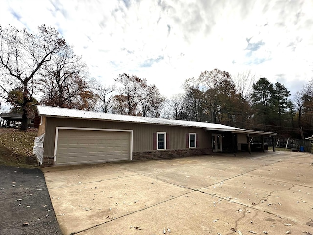 view of front facade featuring a garage and a carport