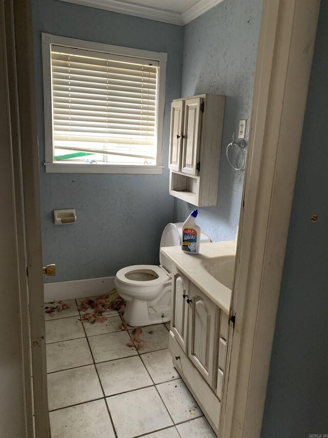 bathroom featuring toilet, tile patterned flooring, vanity, and ornamental molding