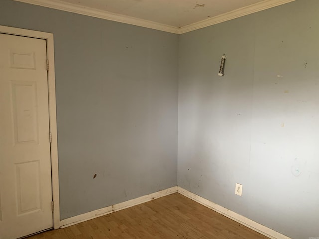 unfurnished room featuring hardwood / wood-style flooring and crown molding