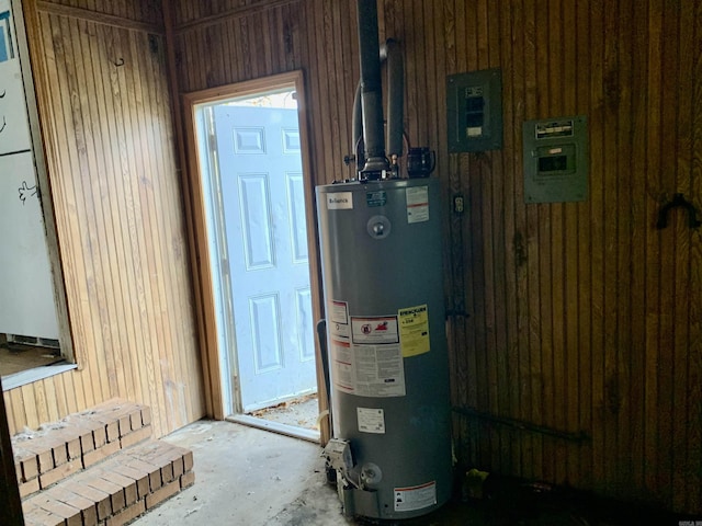 utility room with electric panel and water heater