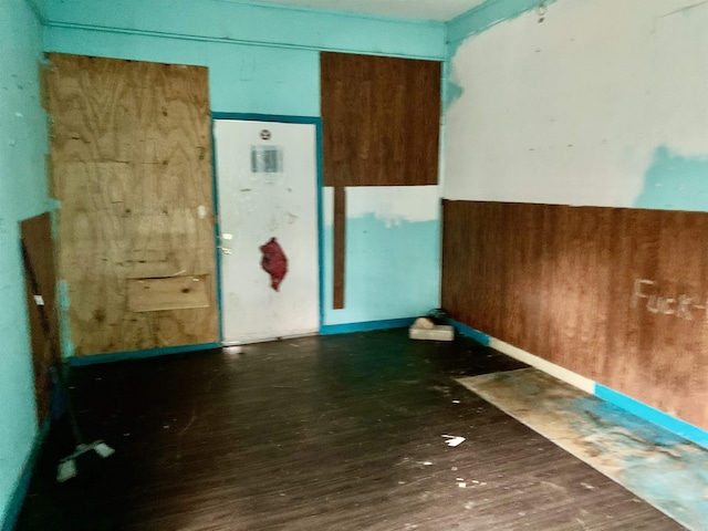 unfurnished room featuring dark hardwood / wood-style flooring