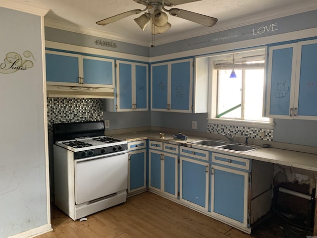 kitchen with backsplash, blue cabinets, sink, white range with gas stovetop, and extractor fan