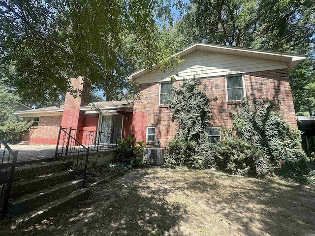 back of house with central AC unit