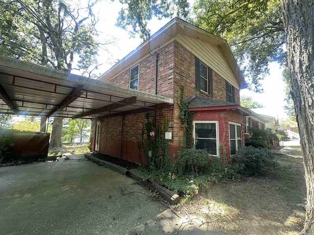 view of side of property featuring a carport