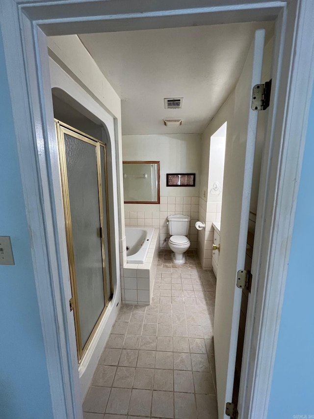 full bathroom with tile patterned floors, vanity, toilet, and plus walk in shower