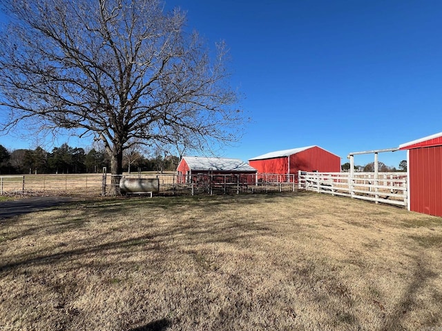 view of yard featuring an outbuilding and a rural view