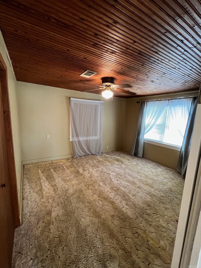 unfurnished room with carpet, ceiling fan, and wooden ceiling