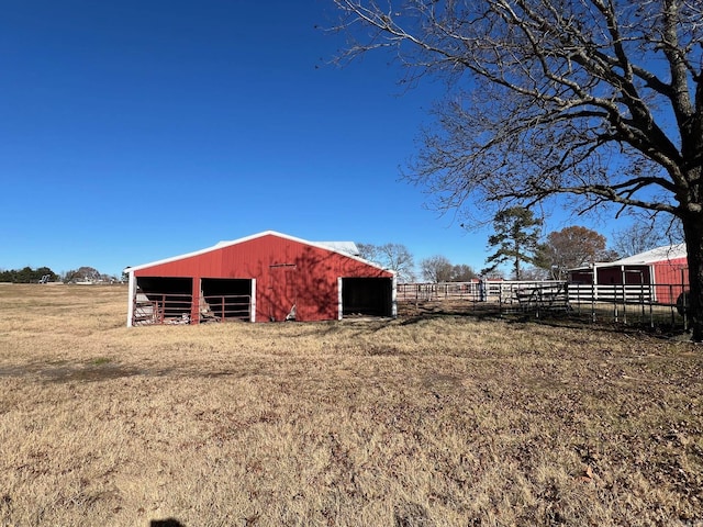 view of yard featuring an outbuilding and a rural view