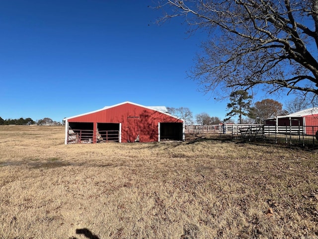 view of yard featuring a rural view and an outdoor structure