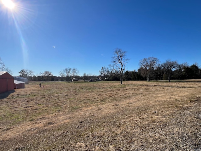 view of yard with a rural view