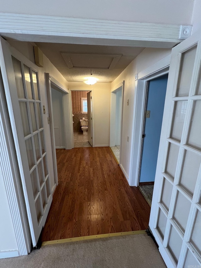 corridor with wood-type flooring