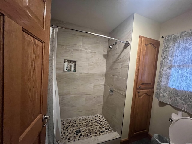 bathroom with a tile shower