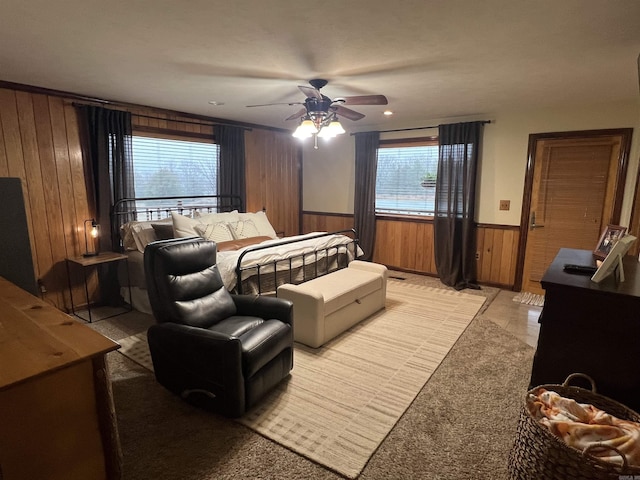 bedroom with wooden walls and ceiling fan