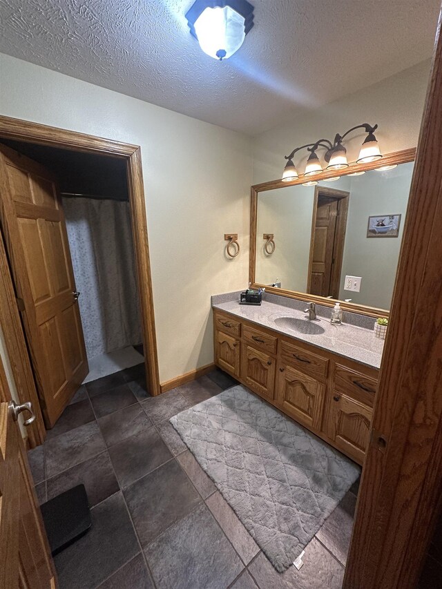 bathroom with a textured ceiling and vanity