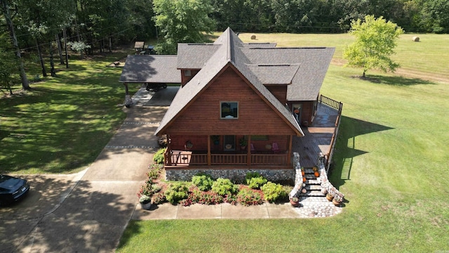 log cabin featuring a porch and a front lawn