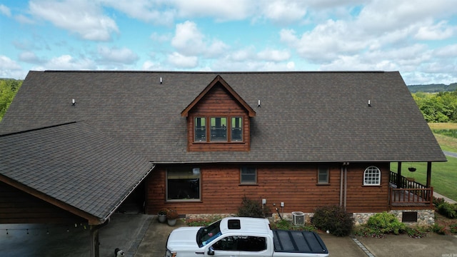 rear view of property with central AC