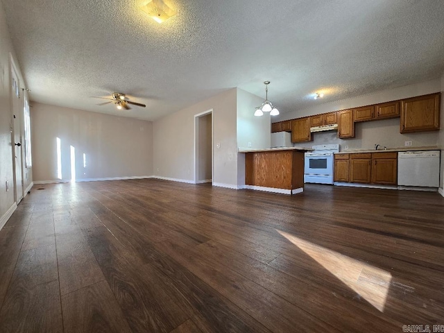 kitchen featuring pendant lighting, ventilation hood, dark hardwood / wood-style flooring, and white appliances