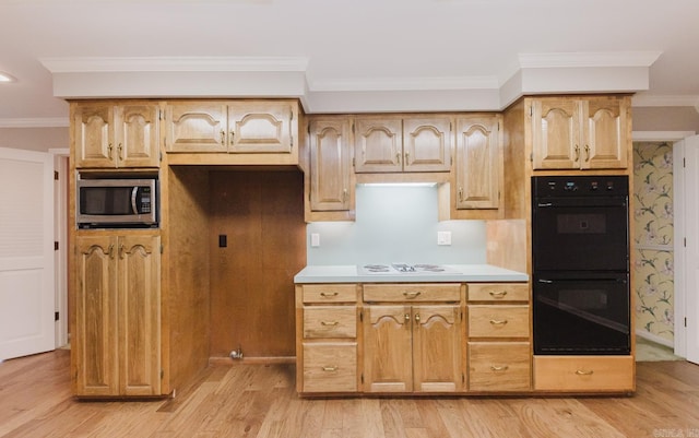 kitchen featuring double oven, ornamental molding, light hardwood / wood-style floors, and light brown cabinetry