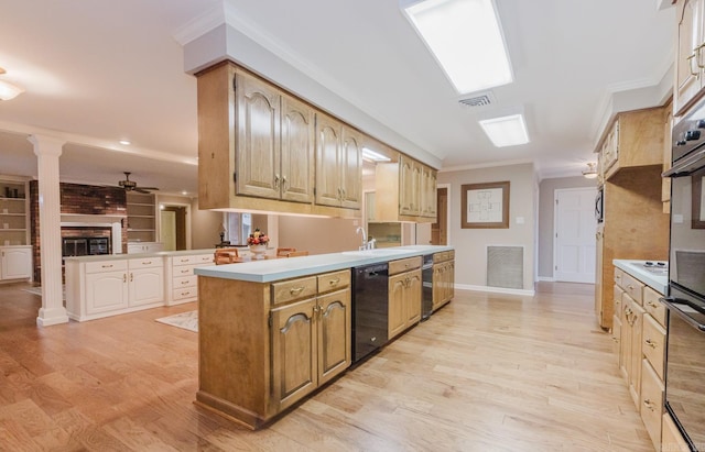 kitchen featuring decorative columns, kitchen peninsula, light hardwood / wood-style floors, dishwasher, and crown molding