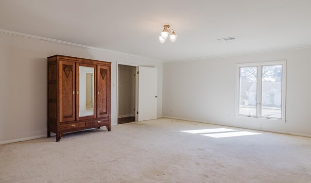 carpeted spare room featuring ornamental molding