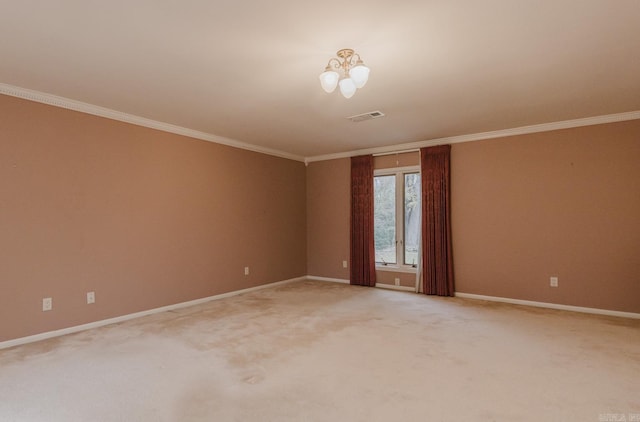 spare room featuring a chandelier, crown molding, and carpet floors