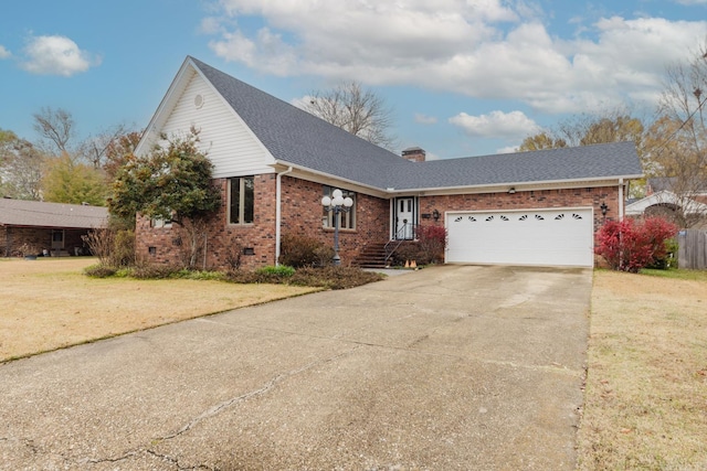 view of front of home with a front yard and a garage