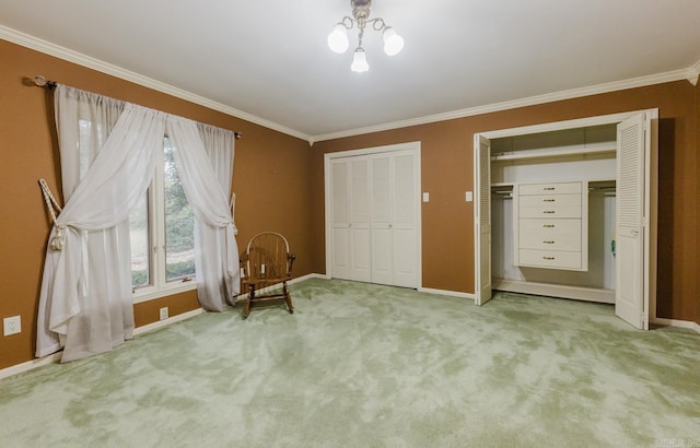 unfurnished bedroom featuring ornamental molding, light carpet, and two closets