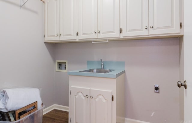 laundry room featuring wood-type flooring, sink, hookup for a washing machine, cabinets, and hookup for an electric dryer