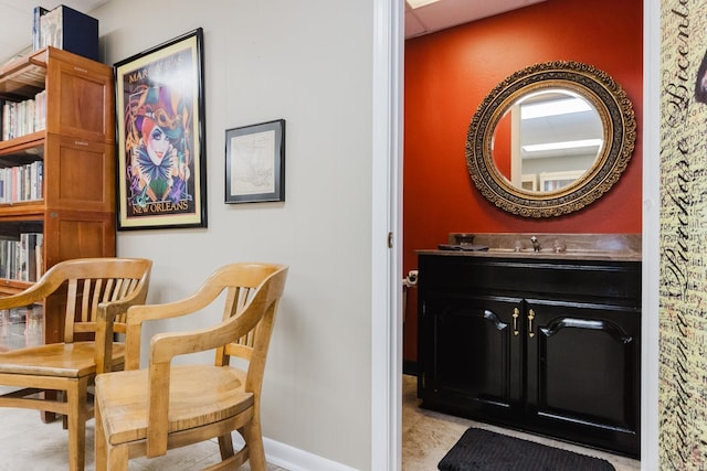 interior space with a paneled ceiling and vanity