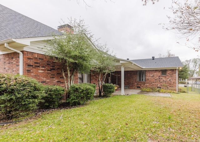 rear view of property with a yard and a patio area