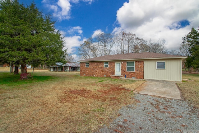 rear view of house featuring a lawn