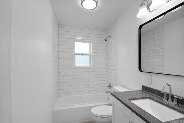 full bathroom featuring vanity, tiled shower / bath combo, and toilet